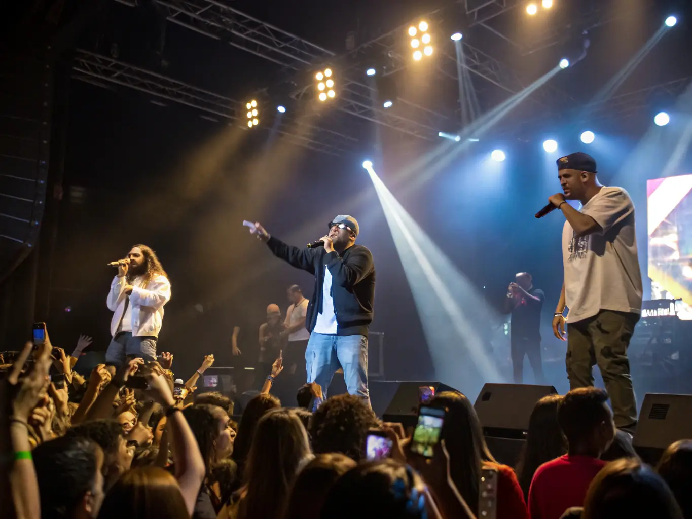 A photograph of a local band performing on stage at a community concert organized by ADM ADM, highlighting the organization's support for local artists.